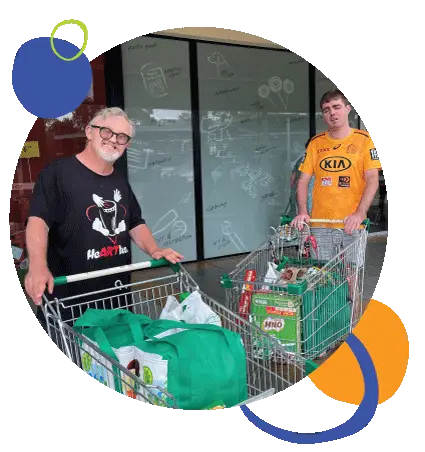 LevelUp Independent Living - Two men pushing shopping carts outside a store.