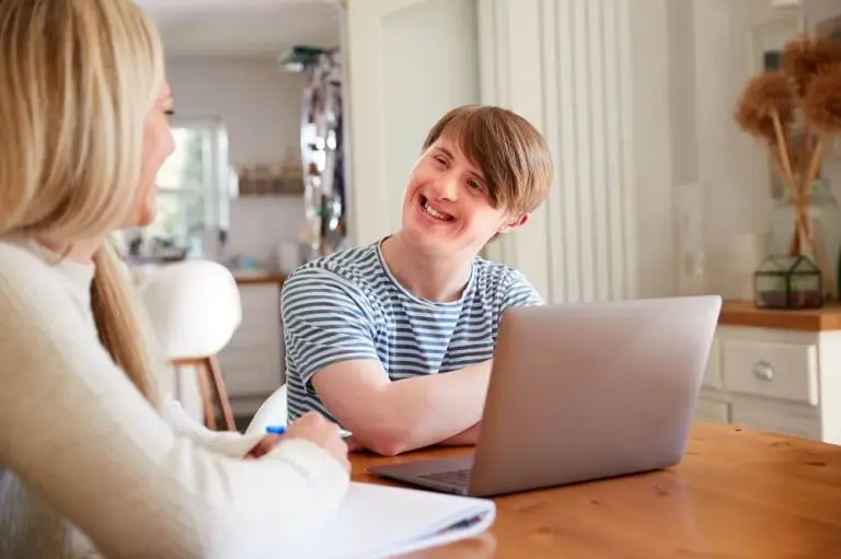 young man with special needs talking with home tutor