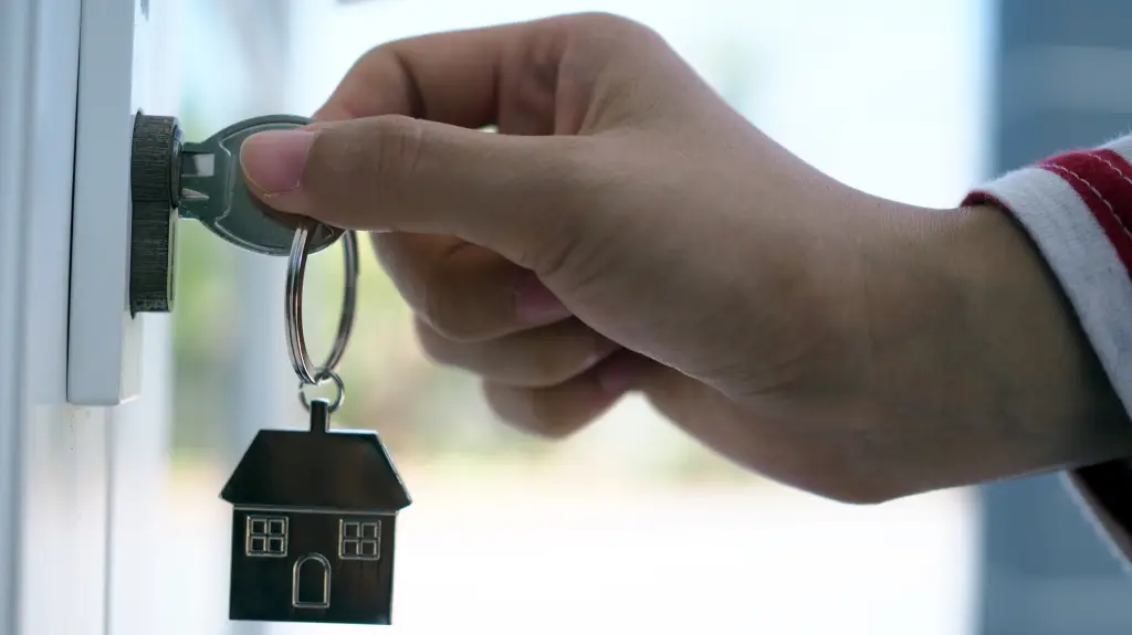 LevelUp Independent Living - Hand holding key with house keychain, symbolizing new beginnings.